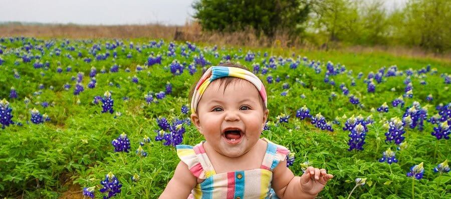 baby in field of purple flowers