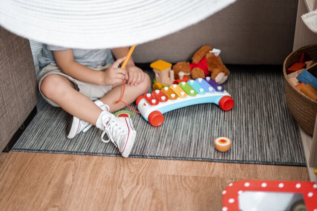 young child on floor playing with toys