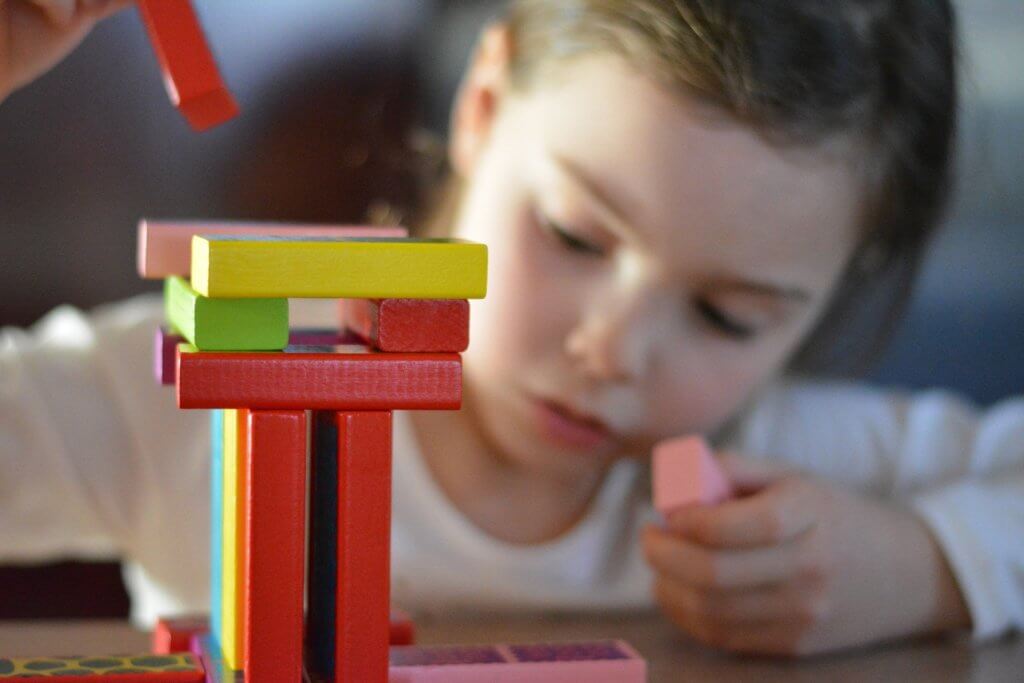 young child playing with blocks