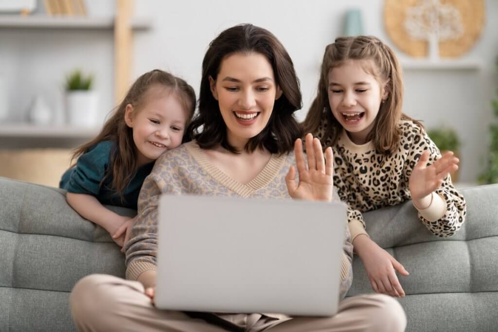 a mother and two daughters with a laptop