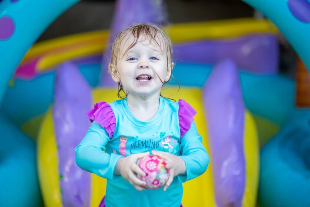 young child playing in water