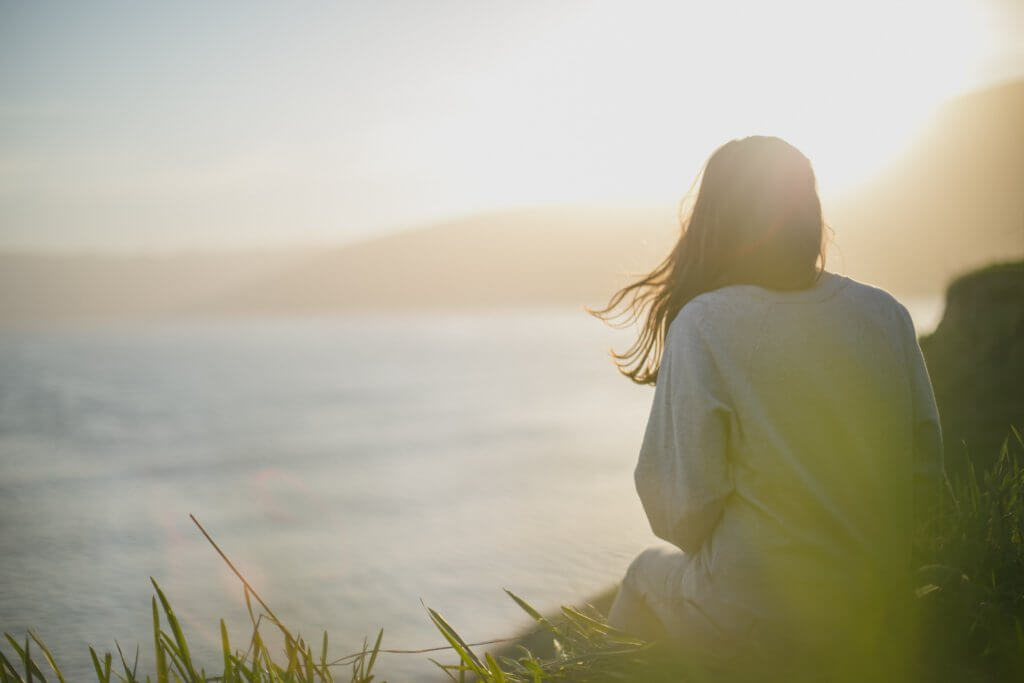 woman staring into sunset