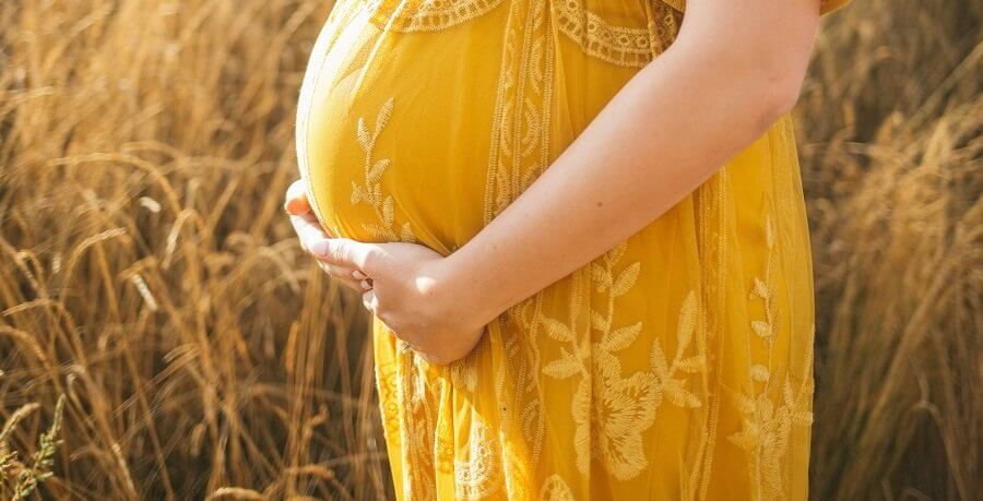 pregnant woman standing outdoors