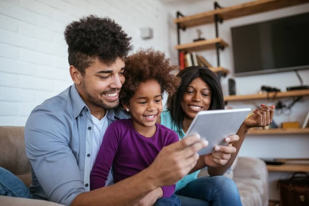 a family video chatting with a tablet