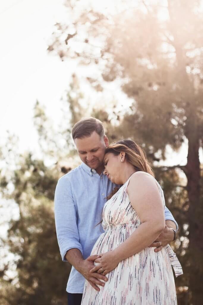 a man comforting a pregnant woman