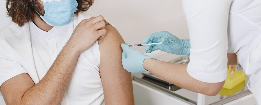 Woman doctor gives a vaccine to patients