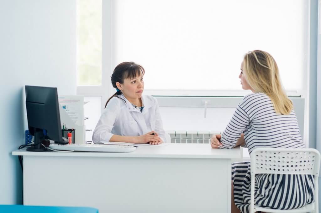 a woman talking to a doctor