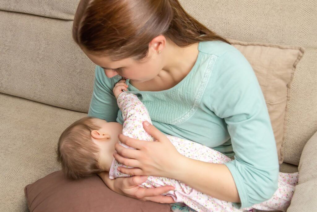 a mom breastfeeding an infant