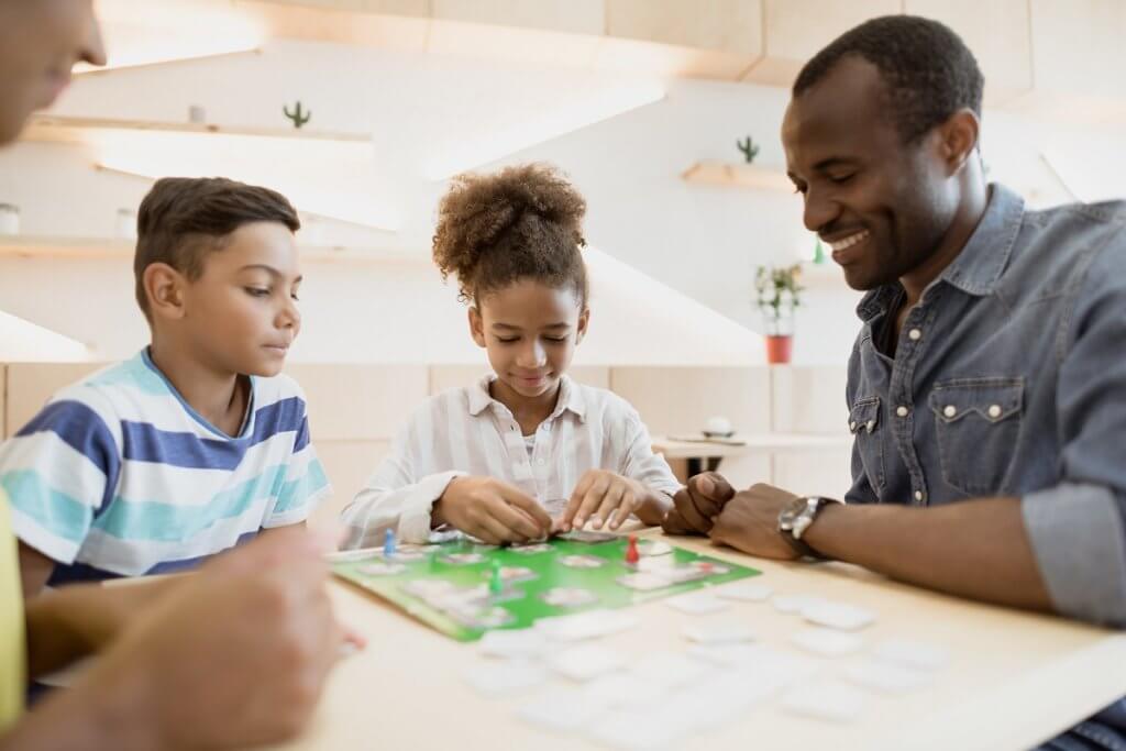 family playing board game in cafe