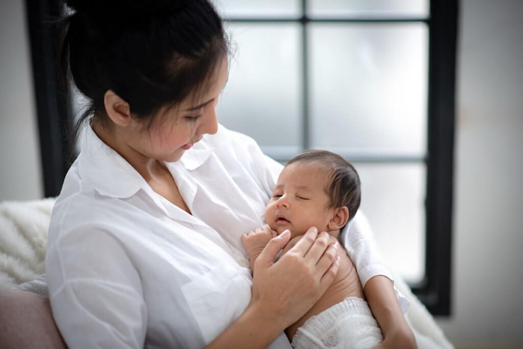 woman holding newborn baby