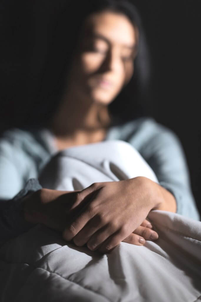 sad woman with close up on her hands