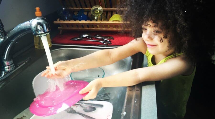 young girl doing dishes