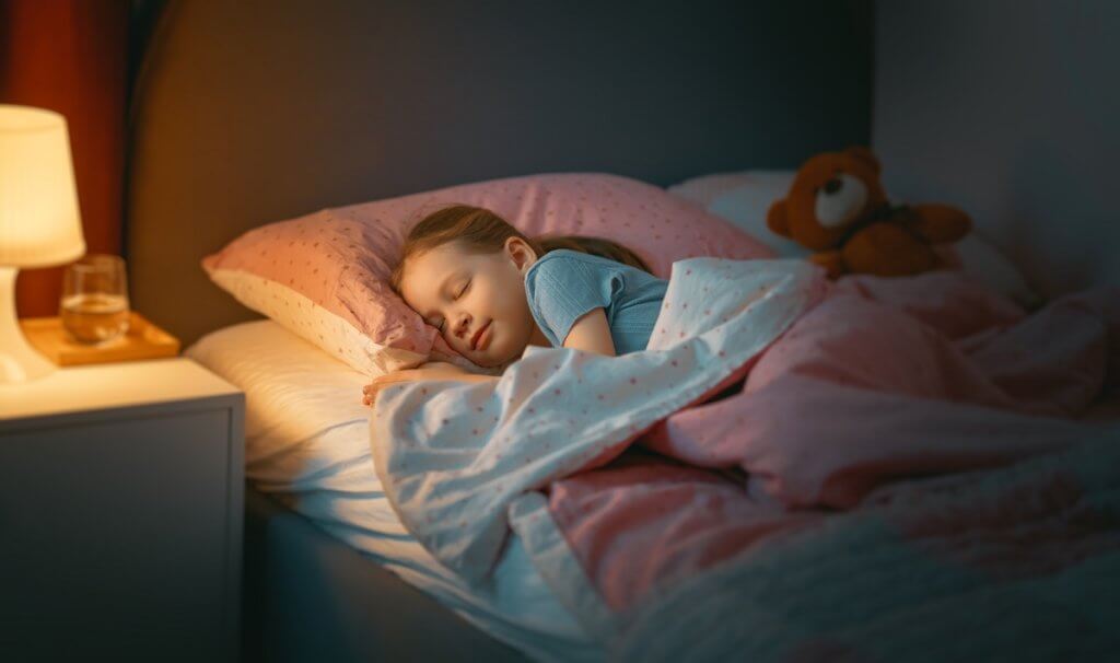 young girl sleeping in bed