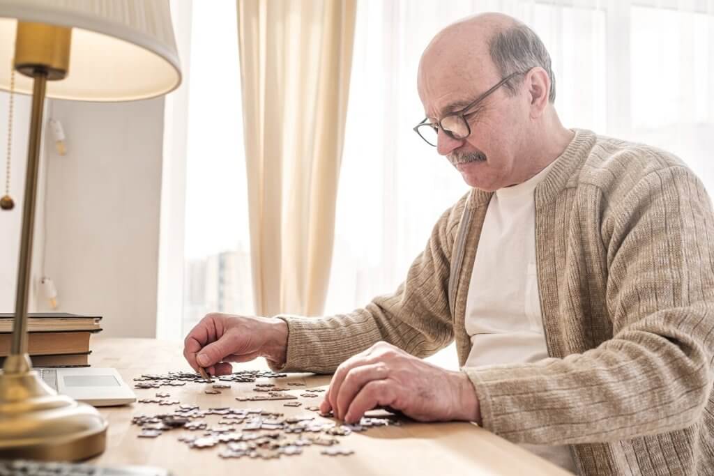 Senior man working on a puzzle