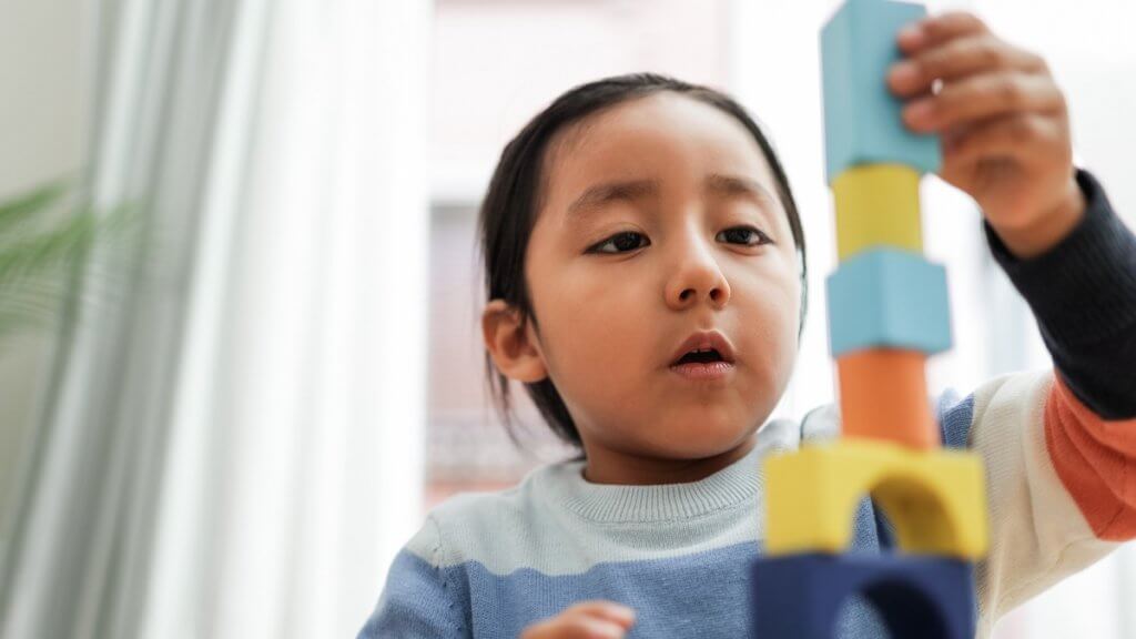 young boy playing with blocks