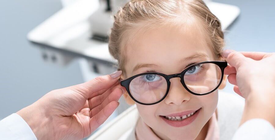 Little girl trying on glasses