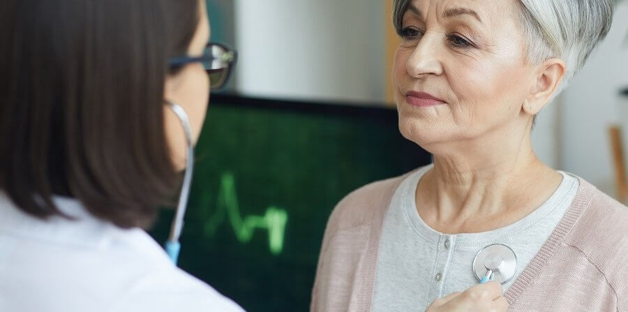 Doctor Listening to Heartbeat of Senior Patient