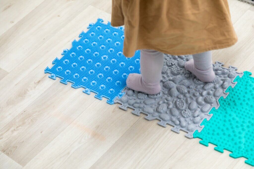 Toddler feet on orthopedic sensory mats